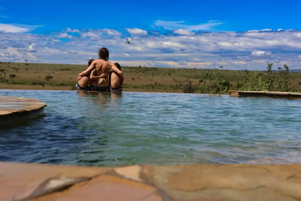 a couple of people that are sitting in a pool a couple of people that are sitting in a pool